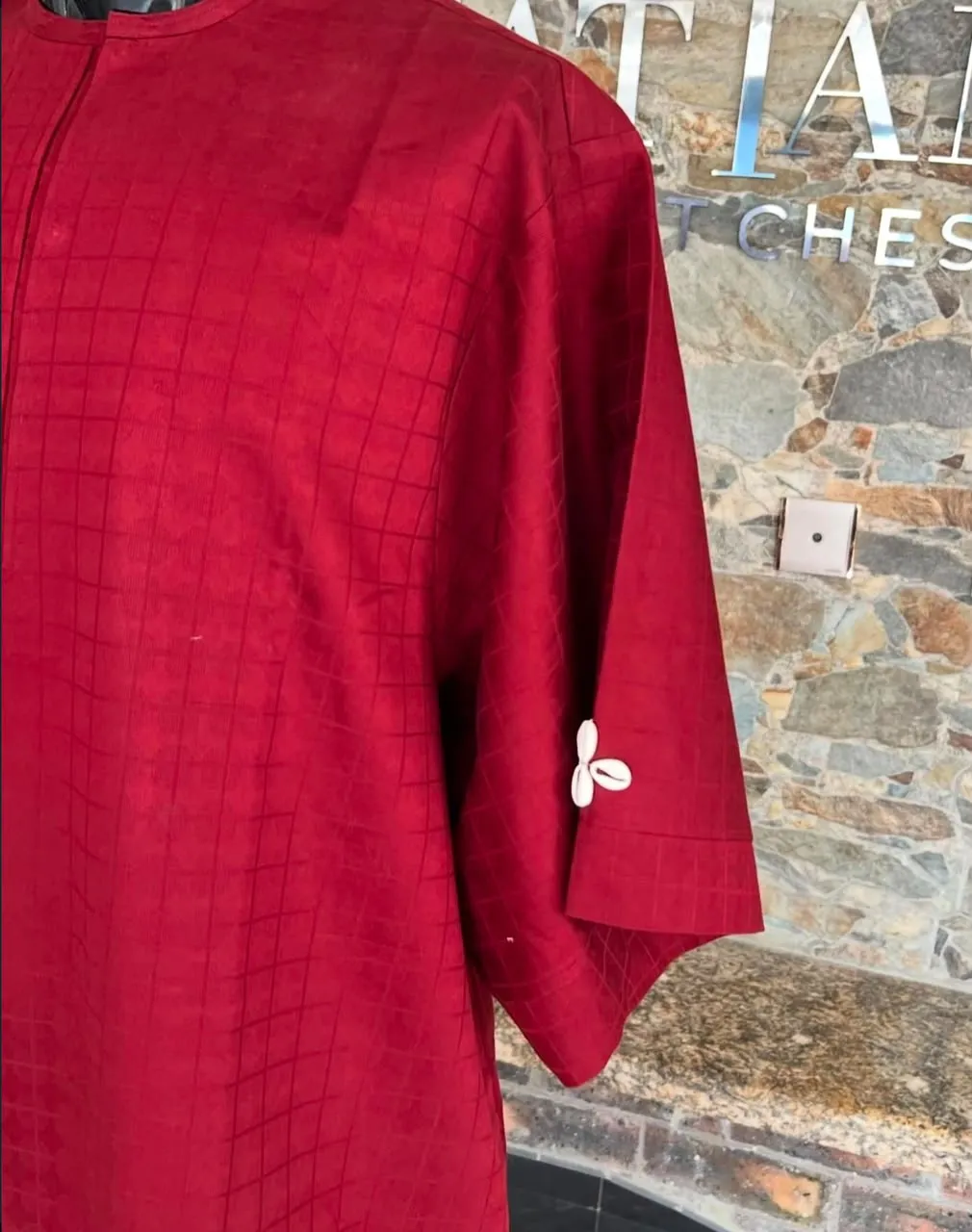 Close look at a wine red tunic with cowrie sleeve detail