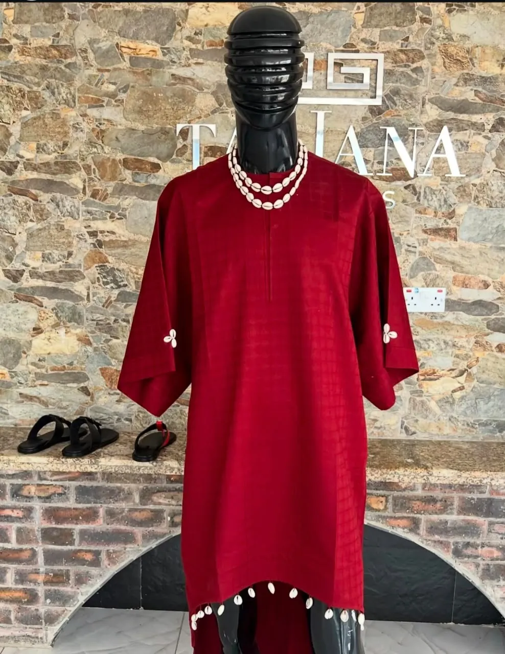 Wine red tunic styled with coral beads on a mannequin