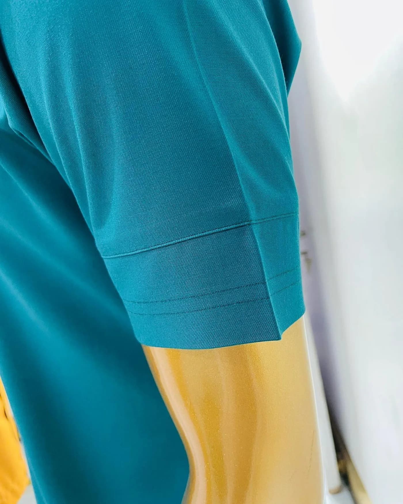 Teal sleeve with a clean turned cuff