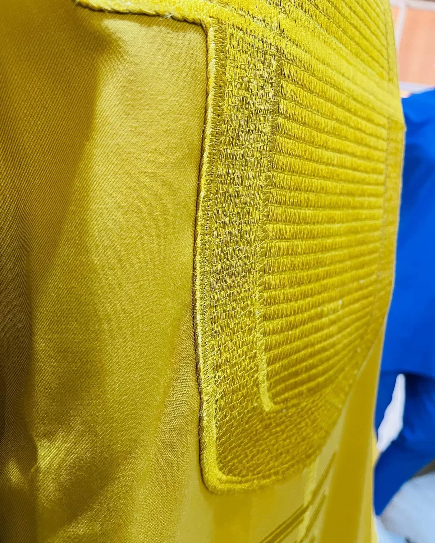 Ribbed embroidery on a mustard agbada