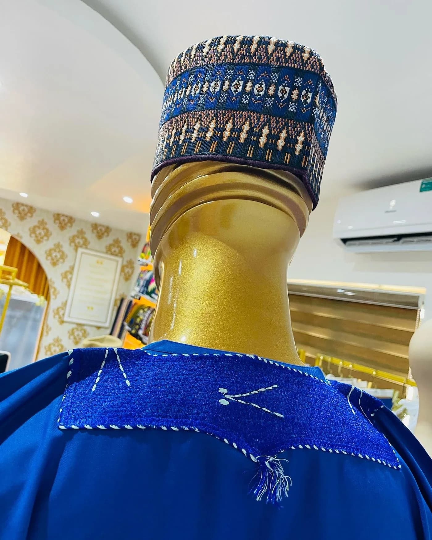Hand stitched shoulder on a blue agbada