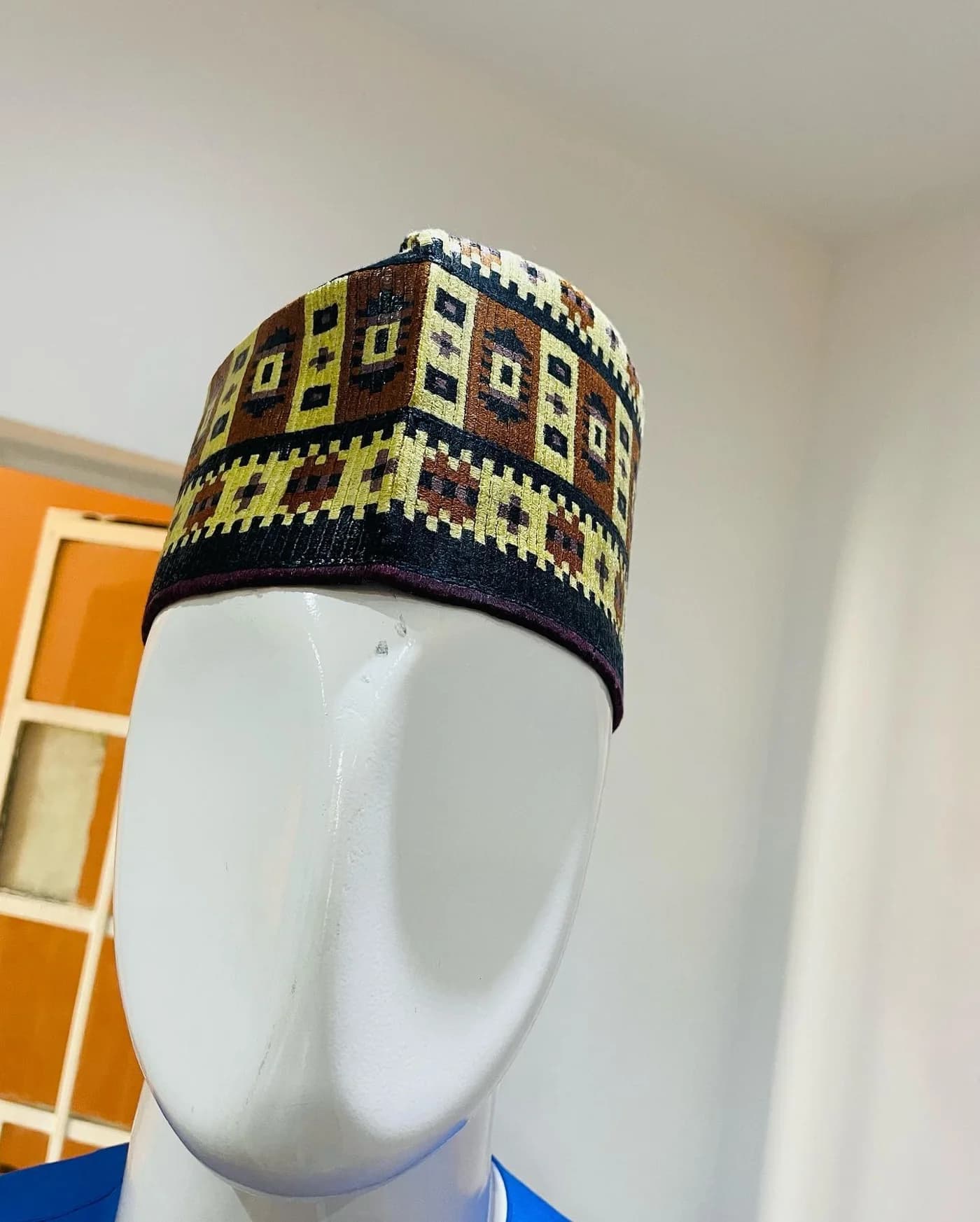 Patterned cap on a white mannequin