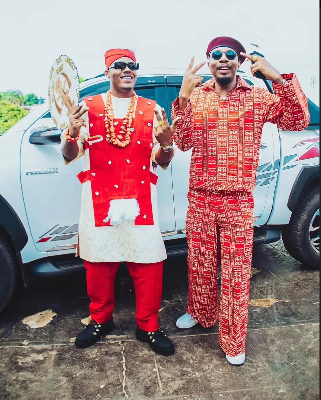 Matching red heritage outfits for a traditional outing