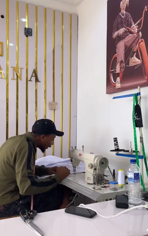 At the sewing machine in the workroom