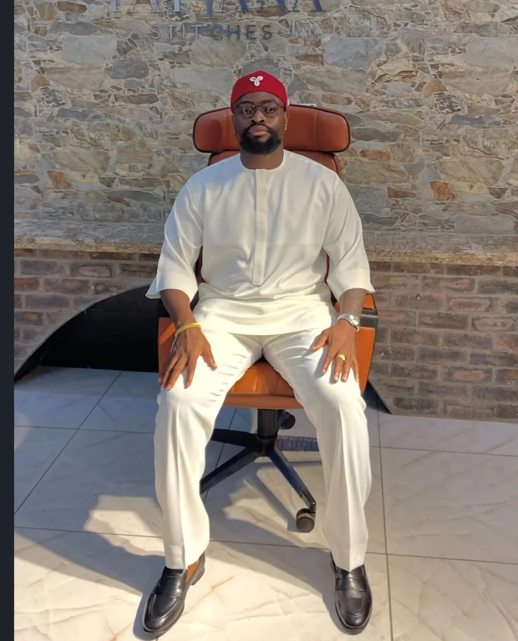 Client seated in an off white senator