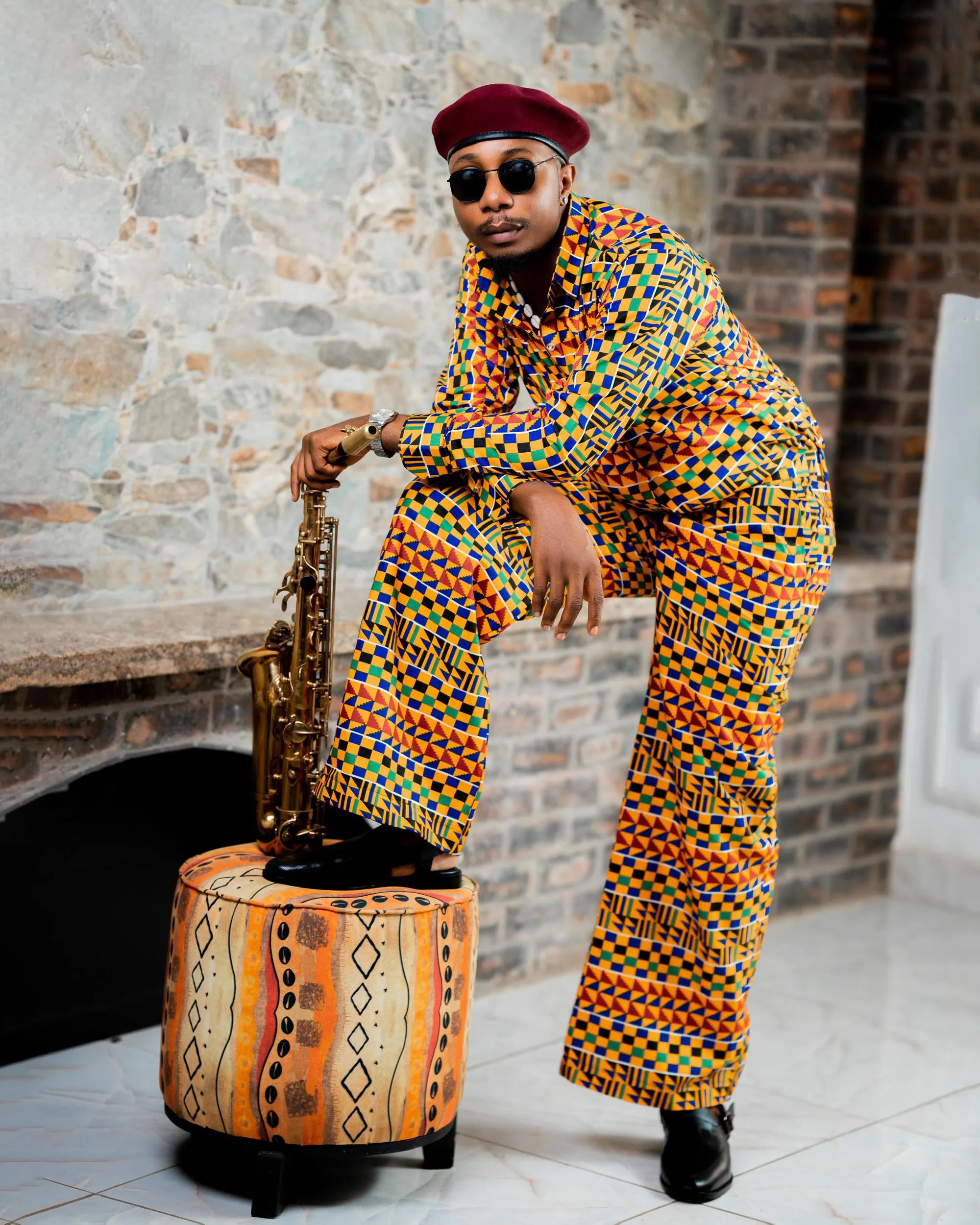 Kente look styled with a leather pouf