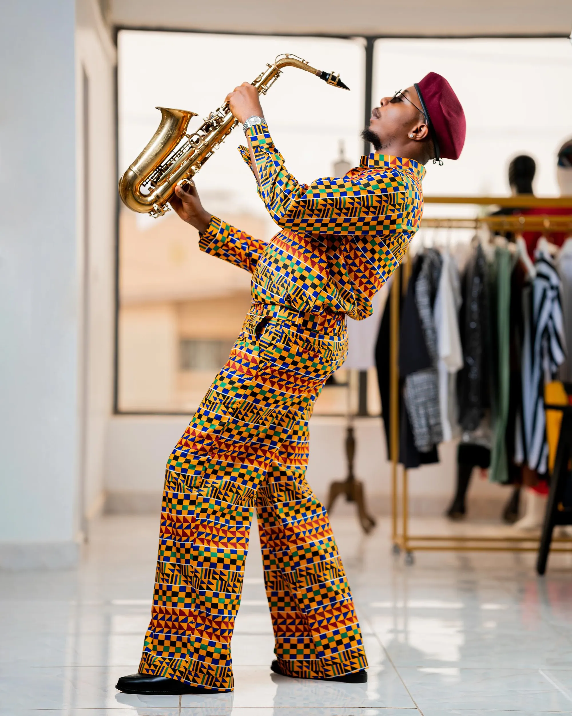 Kente set in motion with a saxophone