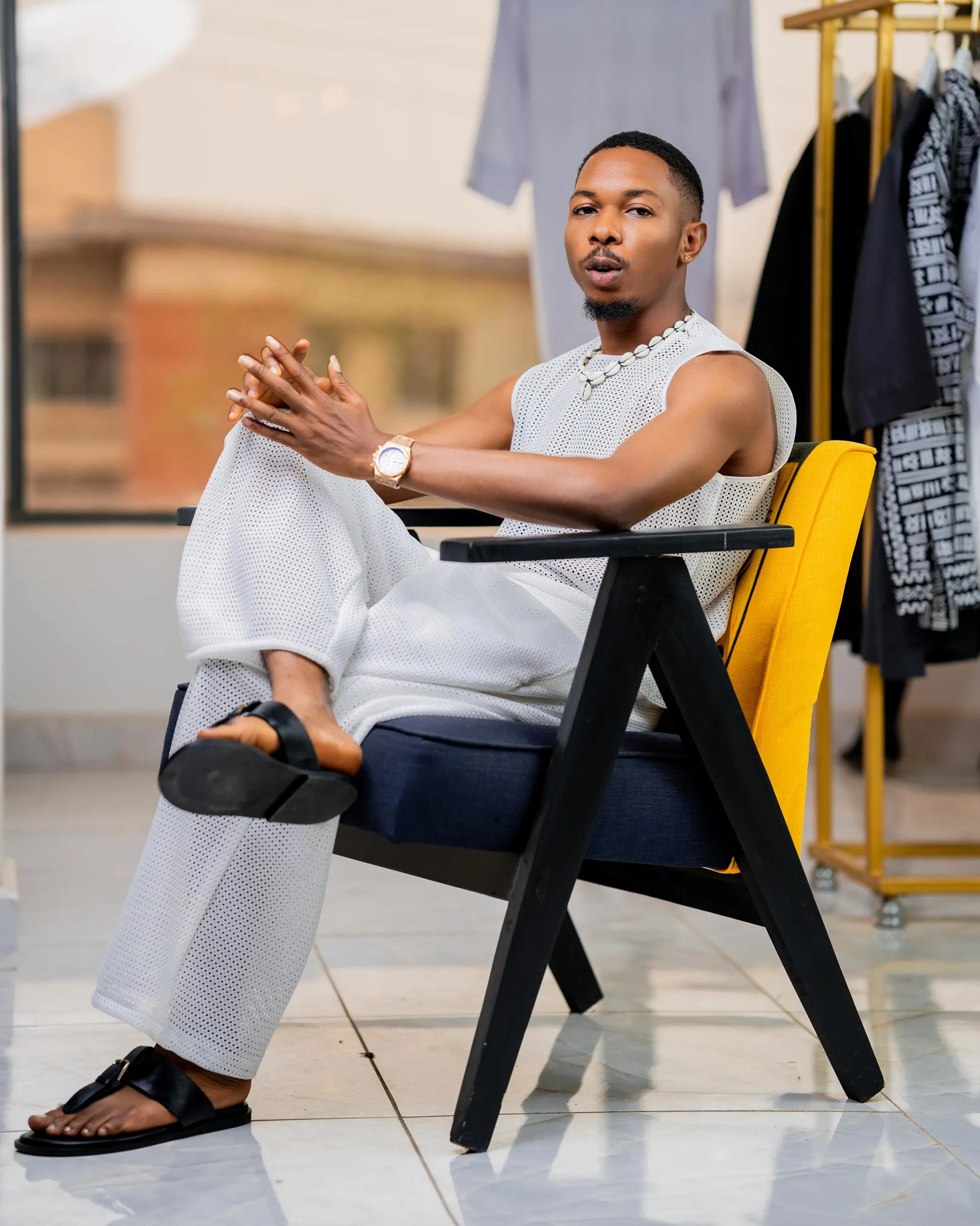 White mesh tank and wide trousers on a yellow chair