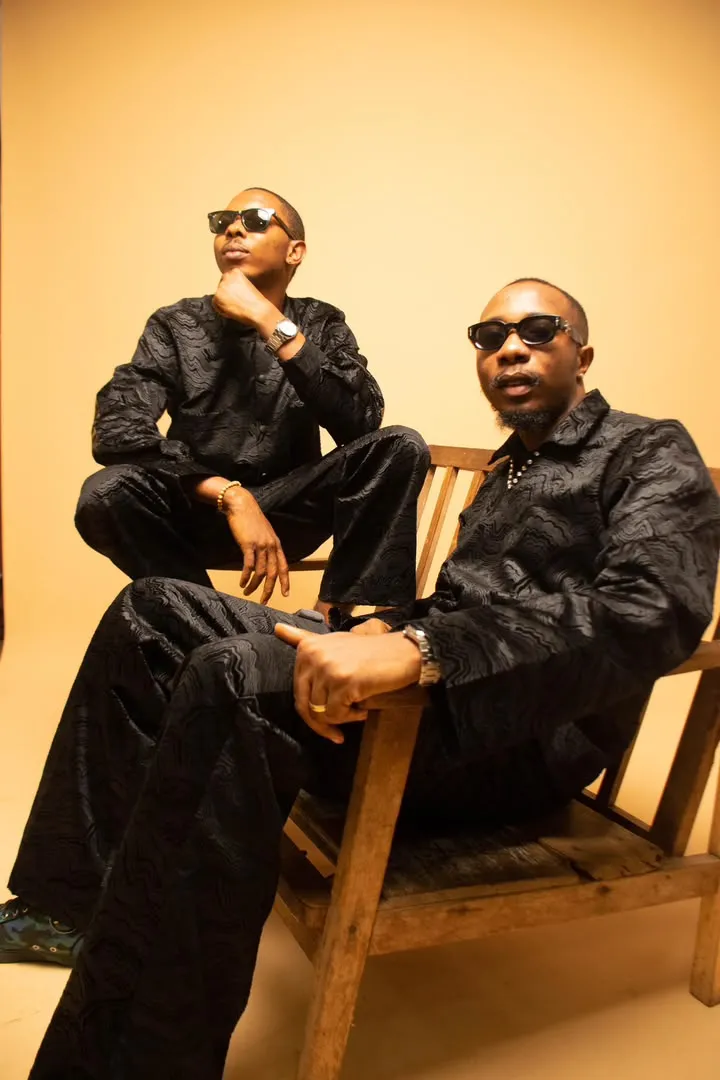 Two looks in black silk, seated