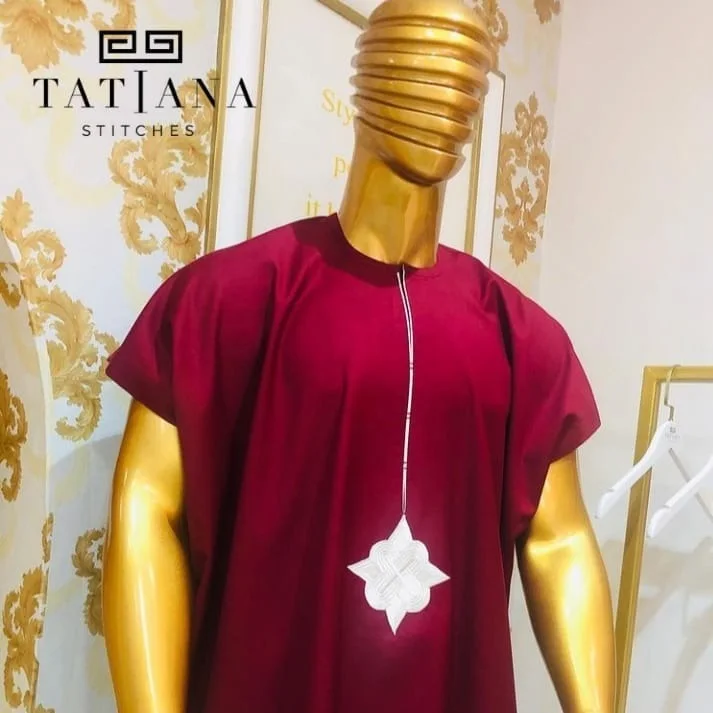 Wine tunic with a white applique on a gold mannequin