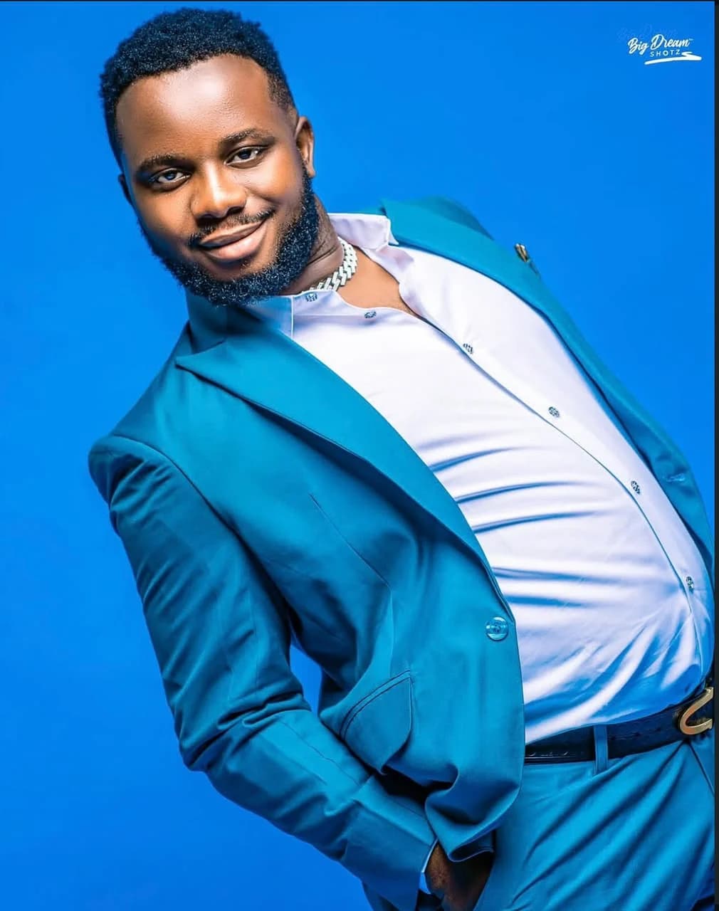 Client in a teal suit and white shirt