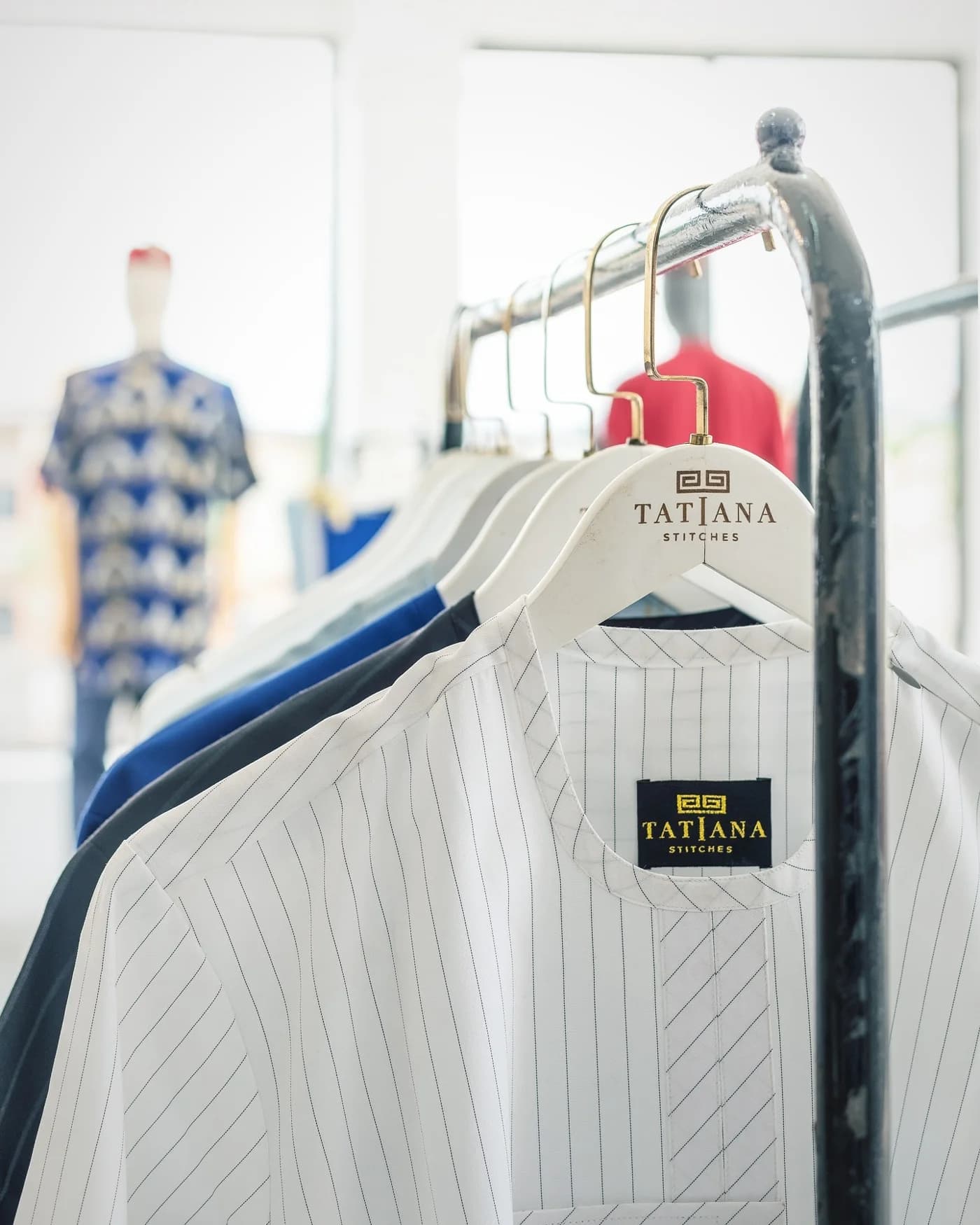Two clients in bold prints inside the showroom